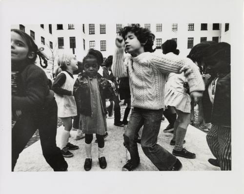 Children dancing on the covered fountain in Westbeth Park, Westbeth Artist Housing, New York City, USA