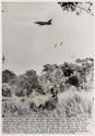 Viet Cong The Burning Issue: American F100 jet drops two canisters of napalm toward a Viet Cong machine gun position on the bank of the Rach Beng river, 70 miles northwest of Saigon, as a soldier of the 1st Battalion, 2nd Infantry, who had been landed by helicopter wades through the tall grass in foreground. The Rach Beng here forms the border between South Vietnam and Cambodia. The infantrymen were landed some 400 yards from the border and moved in to capture hundreds of tons of Viet Cong supplies