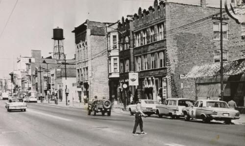 Roosevelt Road is Quiet Today: little traffic, vehicles or pedestrian, in to be seen on Chicago's Roosevelt Road (alternate US 30) following a night of relative calm. Police battled rioters for two nights previous and the Illinois National Guard was brought in. Patrolling jeep with armed guardsmen is seen at center and a police car is parked at right
