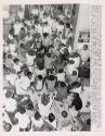 Two hundred Negroes, mostly teenagers, were arrested after police broke up a noisy racial demonstration in the lobby of the First National Bank. The demonstrators were arrested when they sat down on the floor of the bank lobby. The protest was against alleged employment discrimination by the bank, East St. Louis, Illinois.