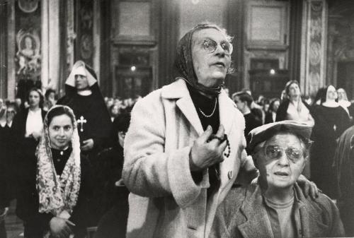 Pilgrims in the foreground, American women in the St. Peter's Cathedral in Rome, Italy