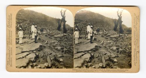 Scientists and Naval Officers exploring the ruins of St. Pierre–covered with volcanic ashes from Mount Pelee, Martinique, W. I.