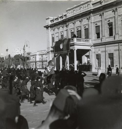 King Farouk's Wedding. Girl guides parading in front of the King and Queen, Cairo, Egypt
