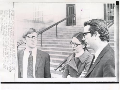 Accused of Conspiracy: John R. Froines, right, a University of Oregon professor, surrendered himself to federal authorities Friday in Portland. He is accused of teaching the use of incendiary devices and conspiring to cause riots at the Democratic National Convention. With him are his wife Ann and his lawyer, her but Titus, a university law school professor, Portland Oregon.