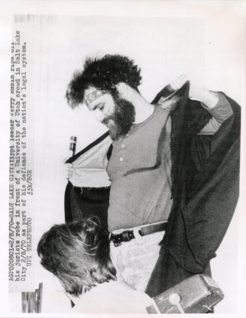Yippie leader Jerry Rubin rips off his jurist's robe in front of a University of Utah crowd in Salt Lake City, Utah as part of his defiance of the nation's legal system.