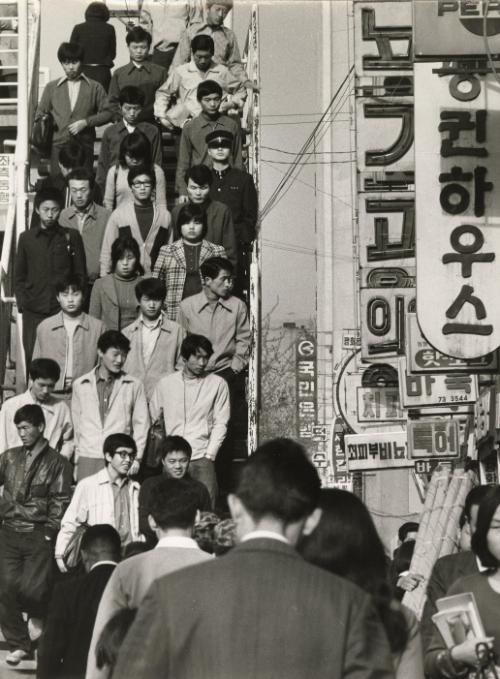 Crowd descends stairs in city center, Japan