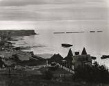 Coastal landscape with World War II tank in yard, England