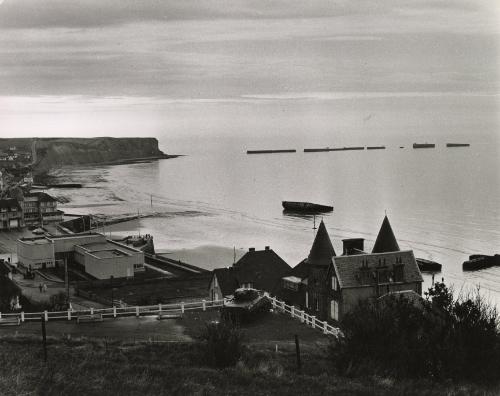 Coastal landscape with World War II tank in yard, England