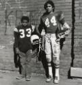 Jose Eskelin (The Policeman) or Football Players, Buffalo, NY
