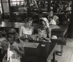 Sewing lessons are still very frequent. Many women born in small villages in the bush never held a needle in their fingers before registering for the "Foyers Social" classes given by the Red Cross, Leopoldville, the Belgian Congo (now Kinshasa, Democratic Republic of the Congo)