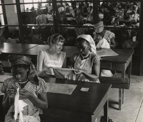 Sewing lessons are still very frequent. Many women born in small villages in the bush never held a needle in their fingers before registering for the "Foyers Social" classes given by the Red Cross, Leopoldville, the Belgian Congo (now Kinshasa, Democratic Republic of the Congo)