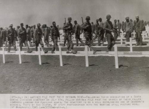 Marines File Past Their Okinawa Dead: following their dedication of a sixth marine division cemetery on July 4th, fellow marines file past the graves of their fallen comrades looking for familiar names. The cemetery is on a hill overlooking one of Okinawa's beaches.