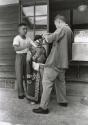 American boy at marital arts school being dressed in traditional costume, Taiwan