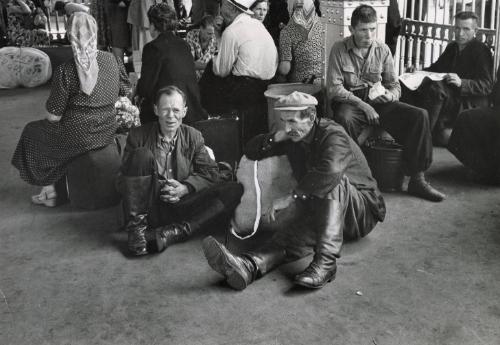 East Berlin to Moscow Via the "Blue Express": these photos show a few typical scenes seen on and from the famed "Blue Express" Railway between Moscow and East Berlin, linking two of the most important of the capitals of the Communist block and carrying thousands of passengers daily on the busy route between these two centers and various points in between. Pictured: Russian peasants in the Moscow Railroad station.